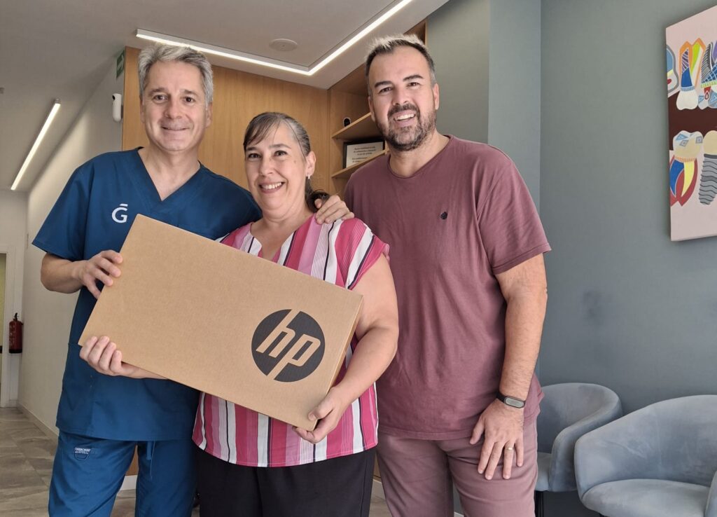 El concejal de Comercio Lucas Jodar entregando uno de los portátiles a una de las ganadoras del sorteo de la campaña La Vuelta al cole